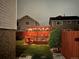 Evening view of the deck in the backyard with pergola and a fire pit at 4912 Altura St, Denver, CO 80239