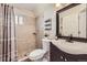 Bathroom features shower with decorative tile, and a modern vanity with dark cabinets at 4912 Altura St, Denver, CO 80239