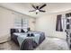 This bedroom offers a comfortable bed with neutral decor, and a ceiling fan at 4912 Altura St, Denver, CO 80239
