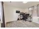 Bedroom features carpeted floors, natural light, and a mounted TV, perfect for a home office at 4912 Altura St, Denver, CO 80239