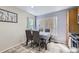 Cozy dining area features neutral walls, large windows, and direct access to the kitchen at 4912 Altura St, Denver, CO 80239