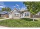 Charming brick home featuring a well-manicured lawn, attached garage, and inviting front entrance at 4912 Altura St, Denver, CO 80239