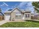 Charming brick home featuring a well-manicured lawn, attached garage, and inviting front entrance at 4912 Altura St, Denver, CO 80239
