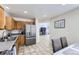 Bright kitchen features stainless steel appliances, wood cabinets and an open view to the living room at 4912 Altura St, Denver, CO 80239