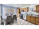 Eat-in kitchen features stainless steel appliances, wood cabinets and is adjacent to the dining area at 4912 Altura St, Denver, CO 80239