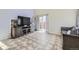 Bright living area showcasing neutral tile flooring, sliding glass doors and modern decor at 4912 Altura St, Denver, CO 80239