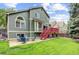 Spacious backyard with a patio, red deck, green lawn, and beautiful landscaping at 6735 W 97Th Cir, Westminster, CO 80021