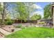 A green backyard with a rock garden and a stone walkway at 6735 W 97Th Cir, Westminster, CO 80021