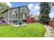 Spacious backyard with a patio, red deck, green lawn, and beautiful landscaping at 6735 W 97Th Cir, Westminster, CO 80021
