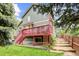 Home's backyard featuring a patio, red deck and stairs, and a grassy lawn at 6735 W 97Th Cir, Westminster, CO 80021