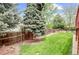Large backyard with green grass, and wooden fence at 6735 W 97Th Cir, Westminster, CO 80021