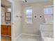 Bright bathroom featuring dual sinks, a tub with jacuzzi jets, and a separate bath area at 6735 W 97Th Cir, Westminster, CO 80021