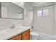 Bright bathroom with wood vanity, modern fixtures, and shower-tub combination at 6735 W 97Th Cir, Westminster, CO 80021