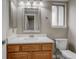 Bathroom featuring a wood vanity, framed mirror and white countertop at 6735 W 97Th Cir, Westminster, CO 80021