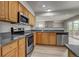 Kitchen with stainless appliances, dark granite counters and wood cabinets at 6735 W 97Th Cir, Westminster, CO 80021