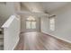 Bright living room featuring vaulted ceilings, large windows, and wood grain floors at 6735 W 97Th Cir, Westminster, CO 80021