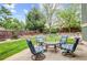 Outdoor patio featuring a table and chairs with lush greenery and landscaping at 6735 W 97Th Cir, Westminster, CO 80021