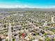 Expansive aerial view of a Gathering-friendly neighborhood, showcasing the home's proximity to local amenities and green spaces at 12978 Dexter St, Thornton, CO 80241