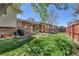 Spacious backyard with green lawn, patio area with seating, and a trampoline, ideal for outdoor enjoyment at 12978 Dexter St, Thornton, CO 80241