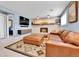 Cozy finished basement with a brick fireplace, leather sofa, and built-in shelves at 12978 Dexter St, Thornton, CO 80241