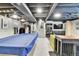 Finished basement features stairs leading up, a dog kennel, and a pool table with a blue cover at 12978 Dexter St, Thornton, CO 80241