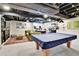 Finished basement features carpeted floors, exercise equipment, and a pool table with a blue cover at 12978 Dexter St, Thornton, CO 80241
