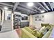 Finished basement with a wet bar, comfortable seating area, and access to the upper levels at 12978 Dexter St, Thornton, CO 80241