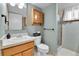 Well-maintained bathroom features a single sink vanity, toilet, and shower with a curtain at 12978 Dexter St, Thornton, CO 80241