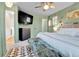 Calm green bedroom featuring a king bed, mounted TV, dresser, and patterned rug at 12978 Dexter St, Thornton, CO 80241