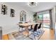 Beautiful dining room with wood table, gray area rug, and wine rack; backyard visible through sliding glass door at 12978 Dexter St, Thornton, CO 80241