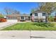 Charming front yard featuring lush green lawn, mature trees, and a well-maintained exterior with a two-car garage at 12978 Dexter St, Thornton, CO 80241