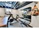 Home gym includes a treadmill, exercise bike, weights, and a mirrored wall at 12978 Dexter St, Thornton, CO 80241