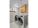 Efficient laundry room featuring front load washer and dryer and cabinet for storage at 12978 Dexter St, Thornton, CO 80241