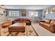 Relaxing living room offers plenty of seating with two sofas and large, decorative area rug at 12978 Dexter St, Thornton, CO 80241
