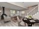 Staged basement with cozy furniture, a dining area, and a charming fireplace at 125 S 22Nd Ave # 6, Brighton, CO 80601