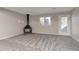 Large basement with a fireplace, neutral walls, and a door leading to the backyard at 125 S 22Nd Ave # 6, Brighton, CO 80601
