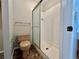 Bathroom featuring a white tiled walk-in shower with glass door and neutral walls at 125 S 22Nd Ave # 6, Brighton, CO 80601