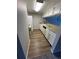 Efficient kitchen with white cabinets, essential appliances, and durable wood-look flooring at 125 S 22Nd Ave # 6, Brighton, CO 80601