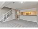 Open-concept living area with stairs, a breakfast bar, and access to other parts of the home at 125 S 22Nd Ave # 6, Brighton, CO 80601