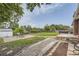 Backyard showing garden, shed, and patio with a table and chairs at 10633 E 6Th Pl, Aurora, CO 80010