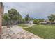 Large backyard with a patio, grassy area, shed, and privacy fence, perfect for outdoor activities and relaxation at 10633 E 6Th Pl, Aurora, CO 80010