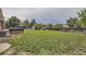 Large backyard featuring expansive lawn, hot tub, a shed, and a privacy fence, creating a private outdoor retreat at 10633 E 6Th Pl, Aurora, CO 80010