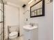 Cozy bathroom features a classic toilet, vanity sink, and shower with a tile surround at 10633 E 6Th Pl, Aurora, CO 80010
