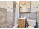 Compact bathroom with tiled walls, modern vanity and a shower with curtain at 10633 E 6Th Pl, Aurora, CO 80010