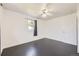 Bright bedroom features sleek dark wood floors, a modern ceiling fan and a sun-filled window at 10633 E 6Th Pl, Aurora, CO 80010