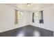 Bright bedroom features sleek dark wood floors and a sun-filled double window at 10633 E 6Th Pl, Aurora, CO 80010