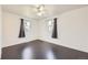 Bright bedroom features sleek dark wood floors, a modern ceiling fan and sun-filled windows at 10633 E 6Th Pl, Aurora, CO 80010