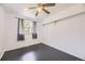 Bright bedroom features sleek dark wood floors, a modern ceiling fan and a sun-filled window at 10633 E 6Th Pl, Aurora, CO 80010