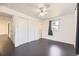 Bright bedroom features sleek dark wood floors, a modern ceiling fan and a sun-filled window at 10633 E 6Th Pl, Aurora, CO 80010
