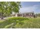 Inviting brick home on a spacious lot with mature trees providing ample shade at 10633 E 6Th Pl, Aurora, CO 80010